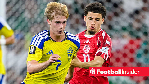 Lucas Bergvall looking down and right while playing for Sweden and getting challenged by a Tunisia player