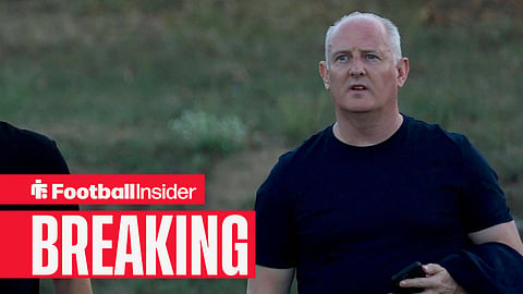 Steve Nickson walking with black T-shirt and jacket on arm