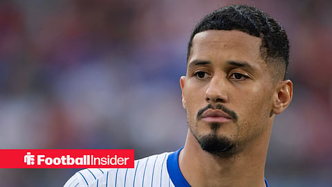 William Saliba in white French kit staring into the distance