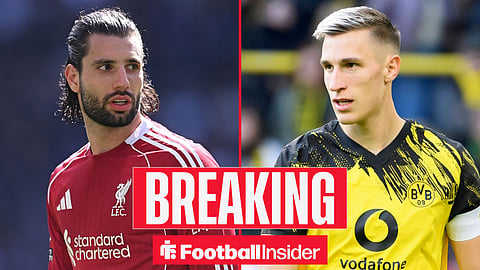 Dominik Szoboszlai in action for Liverpool on left looking at Nico Schlotterbeck in action for Dortmund looking back at him right