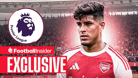 Football Insider exclusive as Arsenal defender Piero Hincapie stares towards the Premier League logo.