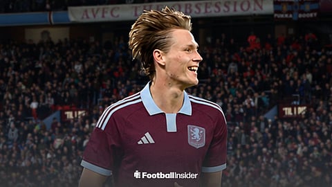 Scott McTominay smiles while wearing an Aston Villa shirt at Villa Park.