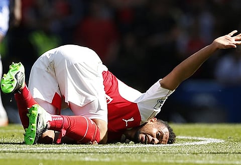 Shattering blow: Coquelin could be out for six months with knee ligament damage