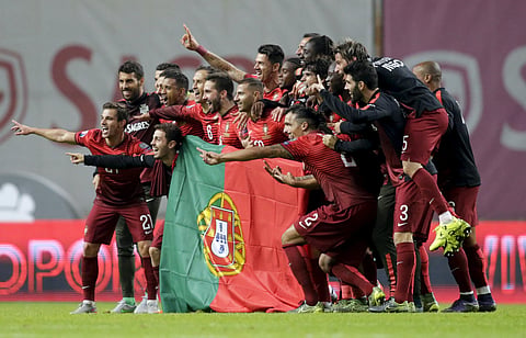 Portugal's team poses with the flag of Portugal at the end their Euro 2016 qualifying soccer match against Denmark at Municipal Stadium in Braga, Portugal, October 8, 2015. REUTERS/Miguel Vidal