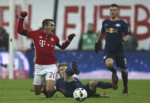 Football Soccer - Bayern Munich v RB Leipzig - German Bundesliga - Allianz-Arena, Munich, Germany - 21/12/16 - Emil Forsberg of RB Leipzig foulds Philipp Lahm of Bayern Munich. REUTERS/Michael Dalder DFL RULES TO LIMIT THE ONLINE USAGE DURING MATCH TIME TO 15 PICTURES PER GAME. IMAGE SEQUENCES TO SIMULATE VIDEO IS NOT ALLOWED AT ANY TIME. FOR FURTHER QUERIES PLEASE CONTACT DFL DIRECTLY AT + 49 69 650050