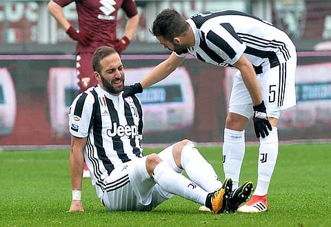 Soccer Football - Serie A - Torino vs Juventus - Stadio Olimpico Grande Torino, Turin, Italy - February 18, 2018 Juventus’ Gonzalo Higuain goes down after sustaining an injury REUTERS/Massimo Pinca
