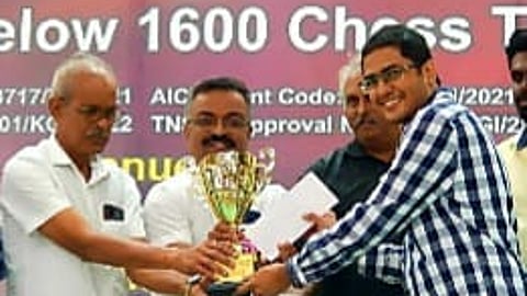 Goa chess player Ameya Avadi accepts the trophy from dignitaries.