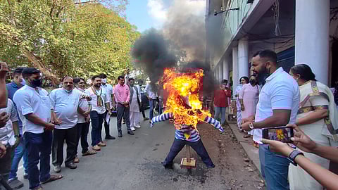 Congress workers burned an effigy of former minister Milind Naik on Friday
