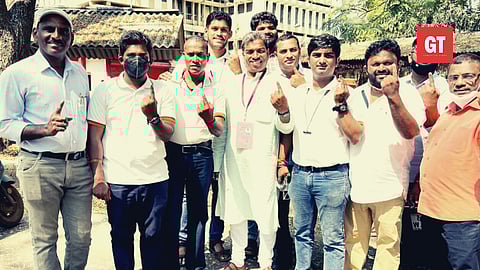 Damu Naik with his supporters after voting.
