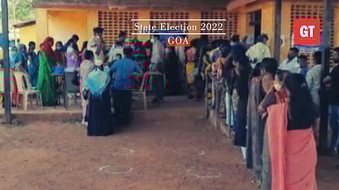 Voters stand in queue at a polling booth in Vasco 