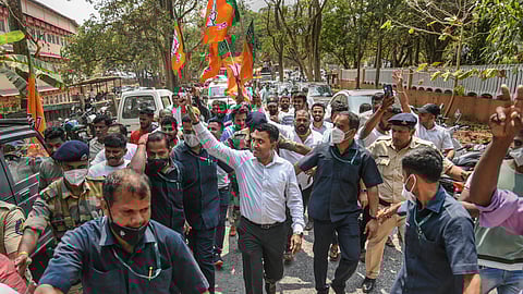 Pramod Sawant flashes the victory sign as BJP leads, during counting day of Goa elections, in Panaji