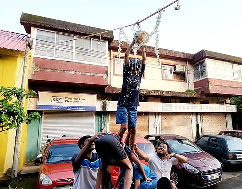 A teenage boy breaks a dahi handi behind Mahalaxmi Mandir in Panjim on the occasion of Janmashtami on Friday.
