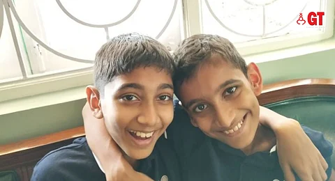 Flashing the cutest smiles, Isaac and Noah Carvalho.