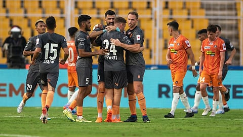Mumbai City FC players exult after scoring a goal.
