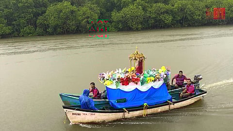 The Sangodd sails in River Mandovi with the statue of Saint Peter.