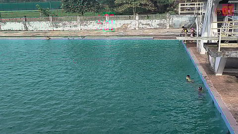 The green, murky waters of the Margao swimming pool.