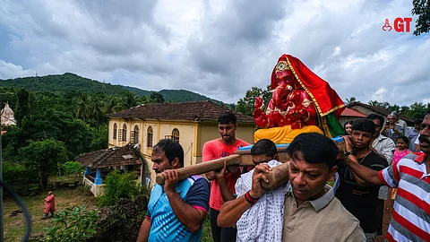 The Suyarao Sardesai family bringing home the red idol of Lord Ganesh at their ancestral house in Savoi-Verem.