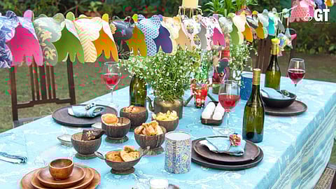 A boho chic aesthetic for your festive table reflects the blues of the Konkan seas with rustic wood and upcycled floral fabric hangings.