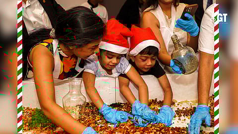 Children and guests participating in the Cake Mixing Ceremony.