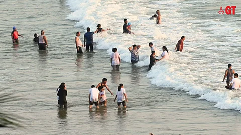 Tourists enjoy on a Goa beach.