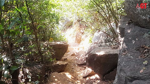 A rocky path leads to Butterfly Beach.