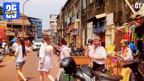Tourists wear the colours of happiness at 'Holi'.