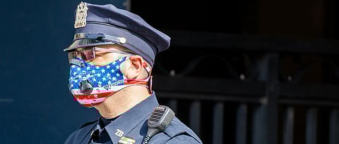 Representational image: Side angle of an NYPD Officer wearing a patriotic American Flag themed N95 Ventilator Mask while on duty in New York City during the difficult period of Coronavirus policing. (Unsplash)