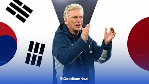 Everton boss David Moyes with Japan and South Korea flags behind him.