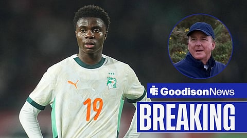 Christ Inao Oulai in action for Ivory Coast next to Everton owner, Dan Friedkin.