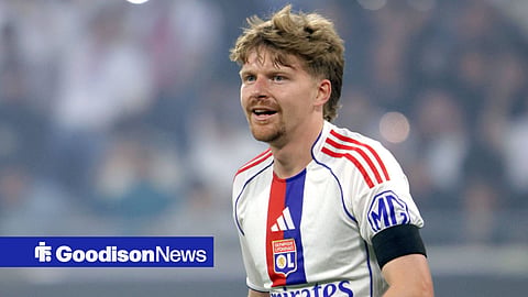 Pavel Sulc looking left and smiling in 25/26 Lyon home kit