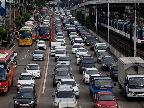 Motorists drive through a heavy traffic flow near a passing metro train along the main highway EDSA in Makati, Metro Manila, Philippines June 21, 2016.