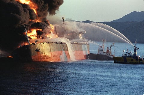 Firefighting vessels douse flames on the Singapore-flagged tanker Norman Atlantic after an attack near the Strait of Hormuz in December 1987, during the Tanker War that exposed the risks of protecting oil routes.