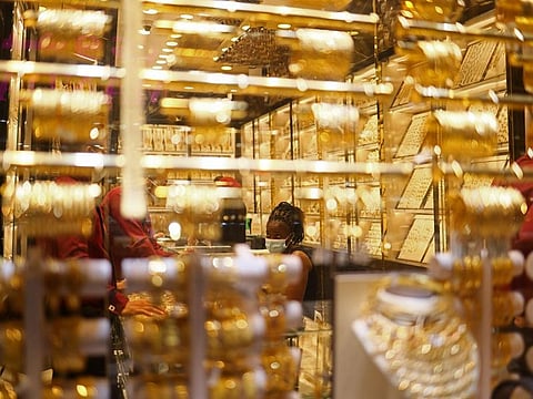 Shoppers browse gold jewellery at a Dubai souk as prices slip below Dh600 per gram for 24K, tracking a global correction in bullion after last week’s rally driven by US inflation data and rate-cut expectations.