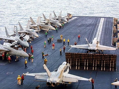 Two US F-18 fighters prepare to take off from a US aircraft carrier. File photo