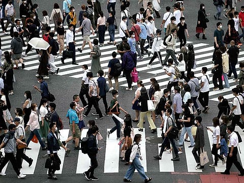 Under new rules that will come into effect in stages, foreign residents wishing to stay in Japan permanently will have to prove their annual income is above average and they can carry casual conversations in Japanese.