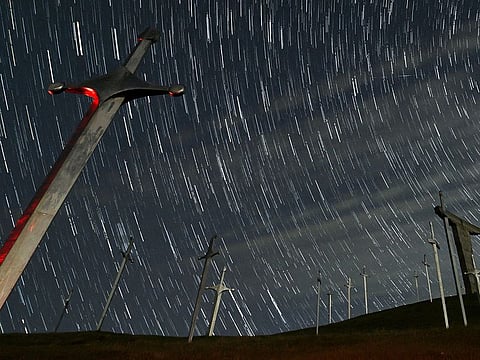 A view shows stars and meteor trails in the night sky above the Battle of Didgori memorial complex during the Lyrid meteor shower in Didgori, Georgia in this composite image of 28 separate photographs. File photo taken on April 22, 2023.