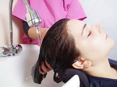 Some reasons for scalp dryness include harsh shampoos, excessive heat styling and hot showers that could rid the scalp of its natural oils.