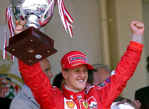 German Ferrari driver Michael Schumacher holds his trophy on the podium of the Monaco racetrack, after winning the 59th Formula One Grand Prix.