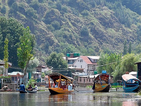 Kashmiri people travel in Shikara boats at Dal Lake in Srinagar on August 18, 2019.