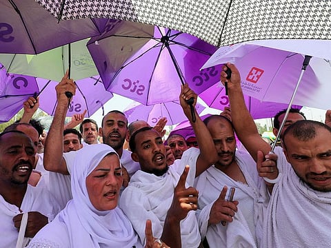Pilgrims carry umbrellas amid high temperatures outside Namira Mosque on the plain of Arafat during the annual Hajj pilgrimage, outside the holy city of Mecca.