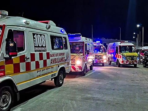 The woman had fainted during the race and was being taken to the hospital in an ambulance stationed at the event site.