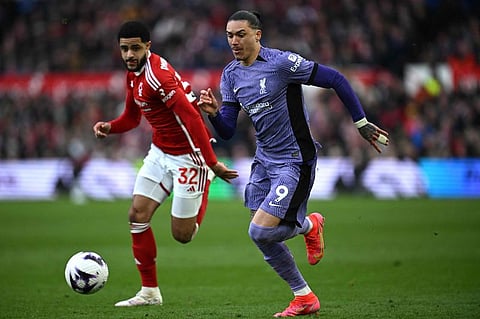 Nottingham Forest's Irish defender Andrew Omobamidele challenges Liverpool's Uruguayan striker Darwin Nunez during an English Premier League match.