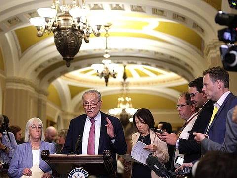 US Senate Majority Leader Sen. Chuck Schumer speaks as (L-R) Sen. Patty Murray and Sen. Maria Cantwell listen during a news briefing after a weekly Senate Democratic policy luncheon at the US Capitol on July 9, 2024 in Washington, DC.