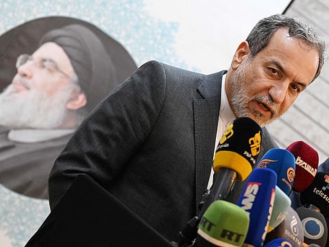Iranian Foreign Minister Abbas Araghchi speaks to the press, in front of the portrait of slain Lebanese Hezbollah leader Hassan Nasrallah, after meeting with Syrian officials at the Iranian embassy in Damascus on October 5, 2024.