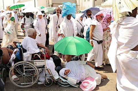 A woman effected by the scorching heat rests as pilgrims arrive to perform the symbolic 'stoning of the devil' ritual as part of the hajj pilgrimage in Mina on June 16, 2024.