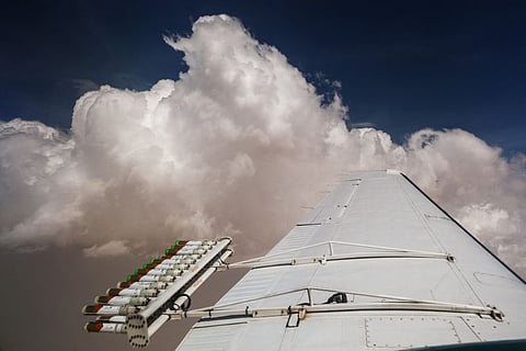 Hygroscopic flares are attached to an aircraft during a cloud seeding flight operated by the National Center of Meteorology.