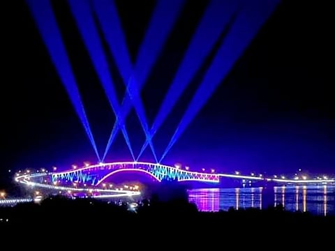 A night-time view of San Juanico Bridge taken in July 2022. Its longest length, at 192 metres, is a steel girder viaduct built on reinforced concrete piers, and its main span is of an arch-shaped truss design.