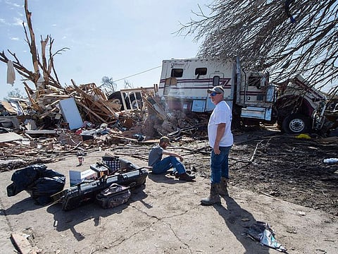 James Brown of Vicksburg, Miss., surveys the damage at the home of his sister Melissa Pierce and her husband, L.A. Pierce, on 7th Street in Rolling Fork, Miss. after a tornado cut through the small Delta town Friday night.