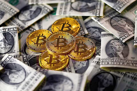 Bitcoin (virtual currency) coins placed on Dollar banknotes are seen in this illustration picture.