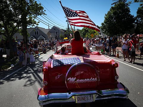 The American flag on an antique car during the annual Fourth of July parade in Barnstable Village, on Cape Cod, Massachusetts, US, on July 4, 2022. The flag is the flag, and it encompasses the whole American idea.